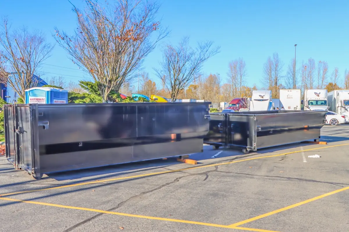 Professional dumpster rental service with roll-off container on residential driveway in Lake Villa